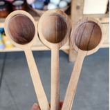 3 wooden scoops are held by a hand