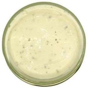 A jar of Kraft Ranch Dressing is showcased, flaunting its classic creamy texture and white hue. The dressing's velvety appearance suggests its smoothness and rich consistency, promising a familiar and beloved flavor profile. Its presentation exudes simplicity and classic appeal, inviting a visual exploration of this well-known and cherished dressing.