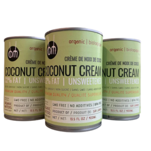 three cans of organic coconut cream on a white background.