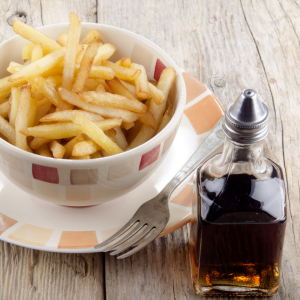  Malt Vinegar, a golden elixir, sits in a classic glass bottle, radiating its rich, amber hue. Its robust aroma hints at the fermented barley essence within. This versatile condiment elevates dishes, from fish and chips to dressings, with a tangy zest that awakens the palate. A kitchen essential for enhancing flavors and adding a delightful touch to any meal.
