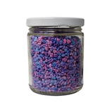 Bright blue and purple sprinkles in a glass jar