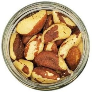 White background with a glass jar filled with Organic Brazil Nuts.