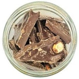 White background with a glass jar filled with Almond Bark.