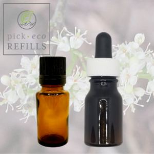Two Essential oil bottles are in front of a picture of the flowers of the Amyris plant.