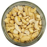 White background with a glass jar filled with Cashew Pieces.