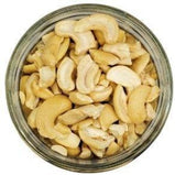 White background with a glass jar filled with Organic Cashew Pieces.