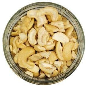White background with a glass jar filled with Organic Cashew Pieces.