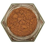 White background with a glass jar filled with Ground Allspice.