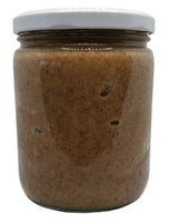White background with a clear, glass jar filled with Raw Almond Butter sealed with a white lid.