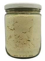 White background with a clear, glass jar filled with Bob's Red Mill Organic Gluten Free Flour sealed with a white lid.