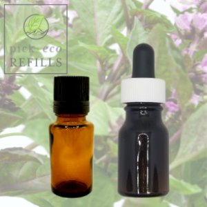 Two Essential oil bottles are in front of a picture of a Basil plant.