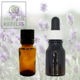 Two bottles of lavender essential oils with lavender flowers in the background.