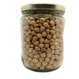 A jar full of dried garbanzo beans on a white background