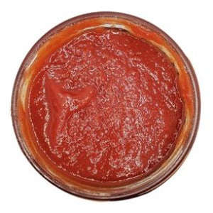 A jar of San Benito Ketchup is displayed, showcasing its vibrant red hue. The ketchup's smooth texture is evident through the clear glass, promising a rich and flavorful condiment. With its enticing color, this ketchup invites a taste of the traditional and beloved San Benito flavor.
