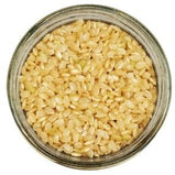 White background with a glass jar filled with Organic Short Grain Lundberg Brown Rice.