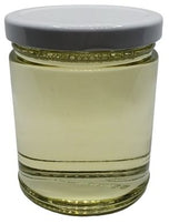 A sleek, transparent jar holds Jojoba Oil Clear Refined, radiating a golden hue under soft light. The oil, pristine and pure, appears lightweight and translucent, exuding a subtle, natural glow. Its refined clarity showcases a smooth texture, promising versatility and purity. As it catches the light, the oil embodies a sense of purity and luxury, inviting you to experience its nourishing and revitalizing properties.