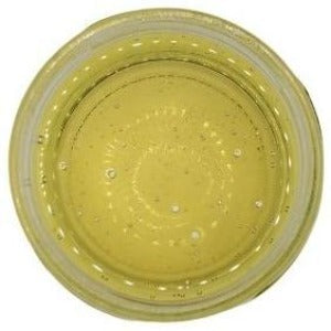 White background with a glass jar filled with Castor Oil.