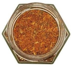 White background with a glass jar filled with Cajun Spice Blend.